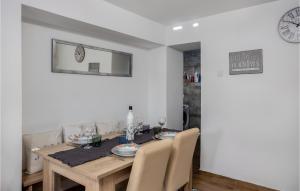 a dining room with a wooden table and chairs at 2 Bedroom Stunning Home In Bregi in Breza