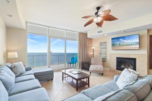 a living room with a couch and a fireplace at Turquoise Place Condos in Orange Beach
