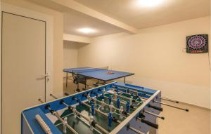 a ping pong room with a ping pong table at Holiday Home Duge Njive With Outdoor Swimming Pool 312 in Duge Njive
