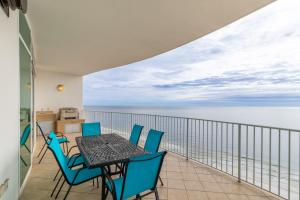 a balcony with a table and chairs and the ocean at Turquoise Place Condos in Orange Beach