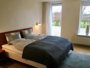 A bed or beds in a room at Børglum Mejeri Hotel