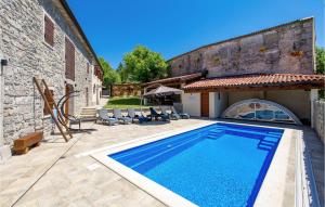 a swimming pool in a yard next to a building at Cozy Home In Vele Mune With Wifi in Vele Mune