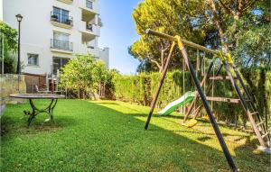 a playground with a slide and a table in a yard at 2 Bedroom Lovely Apartment In Marbella in Marbella
