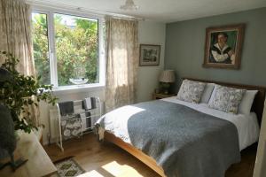 Fuchsia Cottage في Porthallow: غرفة نوم بها سرير ونافذة