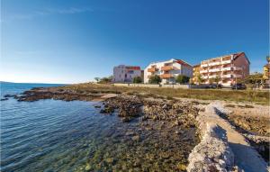 a group of buildings on a beach near the water at Beautiful Apartment In Povljana in Povljana