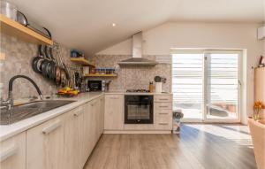 a kitchen with white cabinets and a sink at 3 Bedroom Amazing Apartment In Banjevci in Banjevci