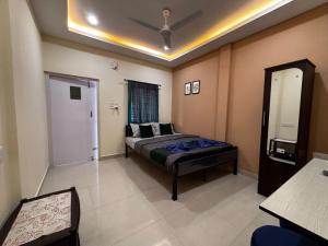 a bedroom with a bed and a mirror in it at The Gulmohar Inn in Guwahati