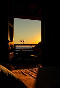 a room with a window with two wine glasses at Mistral-Patmos in Patmos