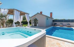a swimming pool in the backyard of a house at 2 Bedroom Gorgeous Home In Zadar in Zadar
