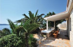 a patio with a table and chairs and the ocean at Beautiful Home In Sevid in Zaglavice