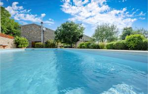 a swimming pool in front of a house at Three-Bedroom Holiday Home In Mratovo in Mratovo +26 photos