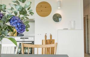 a kitchen with a refrigerator and a table and chairs at Penthouse Comfort in Lembruch +23 photos