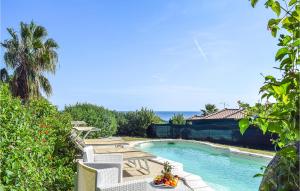 a swimming pool with a table and chairs in a yard at Vespucci in Costa Rei