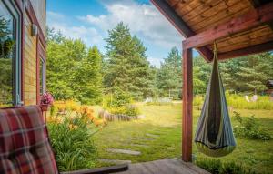 a hammock hanging on the porch of a house at Beautiful Home In Zur With Sauna in Żur +9 photos