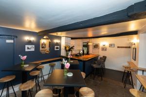 a restaurant with tables and chairs and a counter at The Ancient Unicorn in Barnard Castle