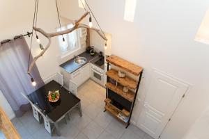 an overhead view of a small kitchen with a table at Le Loft in Honfleur