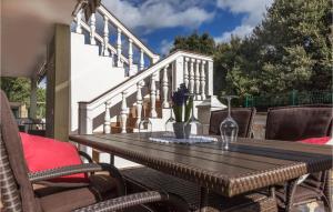 a wooden table and chairs on a patio at Lovely Apartment In Pavicini With Wifi in Pavicini