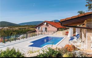 a house with a swimming pool on a balcony at Four-Bedroom Holiday Home In Kijevo in Kijevo