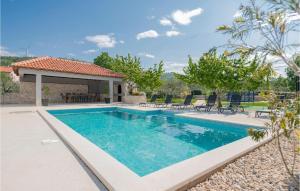 a swimming pool in a villa with a house at Lovely Apartment In Katuni With Wifi in Katuni +26 photos