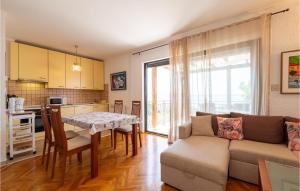 a living room with a couch and a table at Holiday Home Rtina 24 in Rtina