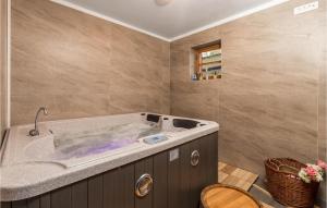 a bathroom with a large tub in a room at Stunning Home In Mrkopalj With Sauna in Mrkopalj