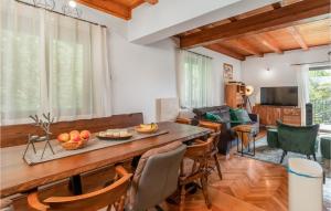 a living room with a wooden table and chairs at Stunning Home In Brod Na Kupi With Wifi in Brod na Kupi