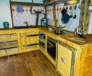 a kitchen with wooden cabinets and a stove in it at BFC Ferienwohnung in Freudenstadt-Grüntal in Freudenstadt +5 photos