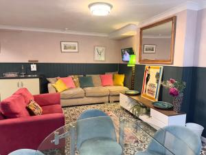 a living room with a couch and a mirror at La Di Da Hotel beach town in Bournemouth