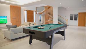 a living room with a pool table and a couch at Rumays House, Barka in Rumays