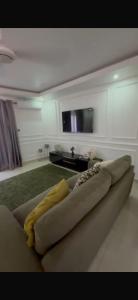 a living room with a couch and a tv at Apartment building in Salagi in Sukuta