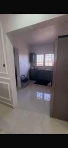 an empty room with a kitchen in a house at Apartment building in Salagi in Sukuta