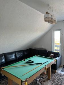 a pool table in a living room with a couch at Elen in Goliševa