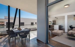 a dining room and living room with a table and chairs at Awesome Apartment In Zidarici With Wifi in Vantačići