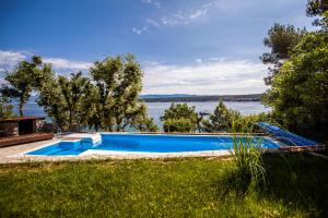 a swimming pool with a view of the water at Apartments Ana in Malinska