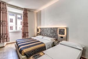 Postel nebo postele na pokoji v ubytování Hotel principe