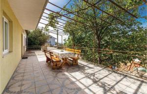 a patio with a table and chairs on a balcony at Lovely Apartment In Sveti Juraj in Sveti Juraj