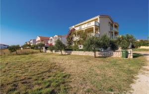a large house on a hill with a yard at Beautiful Apartment In Povljana in Povljana