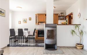 a kitchen with a stove and a table with chairs at Beautiful Apartment In Povljana in Povljana