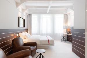 Postel nebo postele na pokoji v ubytování Ruby Lotti Hotel Hamburg