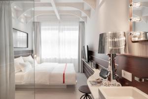 Postel nebo postele na pokoji v ubytování Ruby Lotti Hotel Hamburg