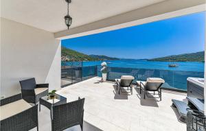 a balcony with chairs and a view of the water at 3 Bedroom Nice Apartment In Marina in Marina