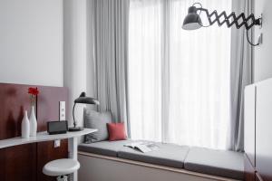 Postel nebo postele na pokoji v ubytování Ruby Lilly Hotel Munich