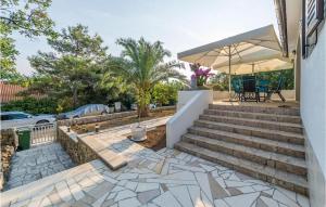 a patio with stairs and a table and chairs at Pet Friendly Home In Potocnica in Potocnica