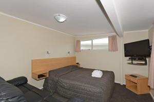 מיטה או מיטות בחדר ב-Trentham Motel