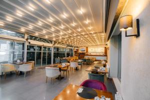 a dining room with tables and chairs and windows at Asia City Hotel Istanbul in Istanbul