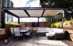 a patio with a couch and a table and chairs at Hotel Grand Ansara Mentari in Baturaja