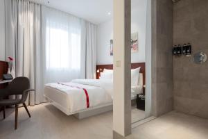 Postel nebo postele na pokoji v ubytování Ruby Marie Hotel Vienna