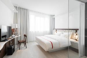 Postel nebo postele na pokoji v ubytování Ruby Lissi Hotel Vienna