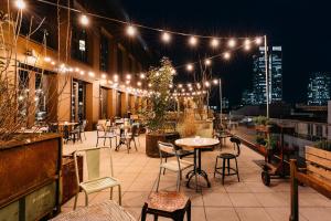フランクフルト・アム・マインにあるRuby Louise Hotel Frankfurtの屋上パティオ(テーブル、椅子、照明付)