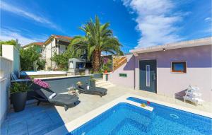 a swimming pool next to a house with a house at 5 Bedroom Cozy Home In Okrug Donji in Okrug Donji +51 photos